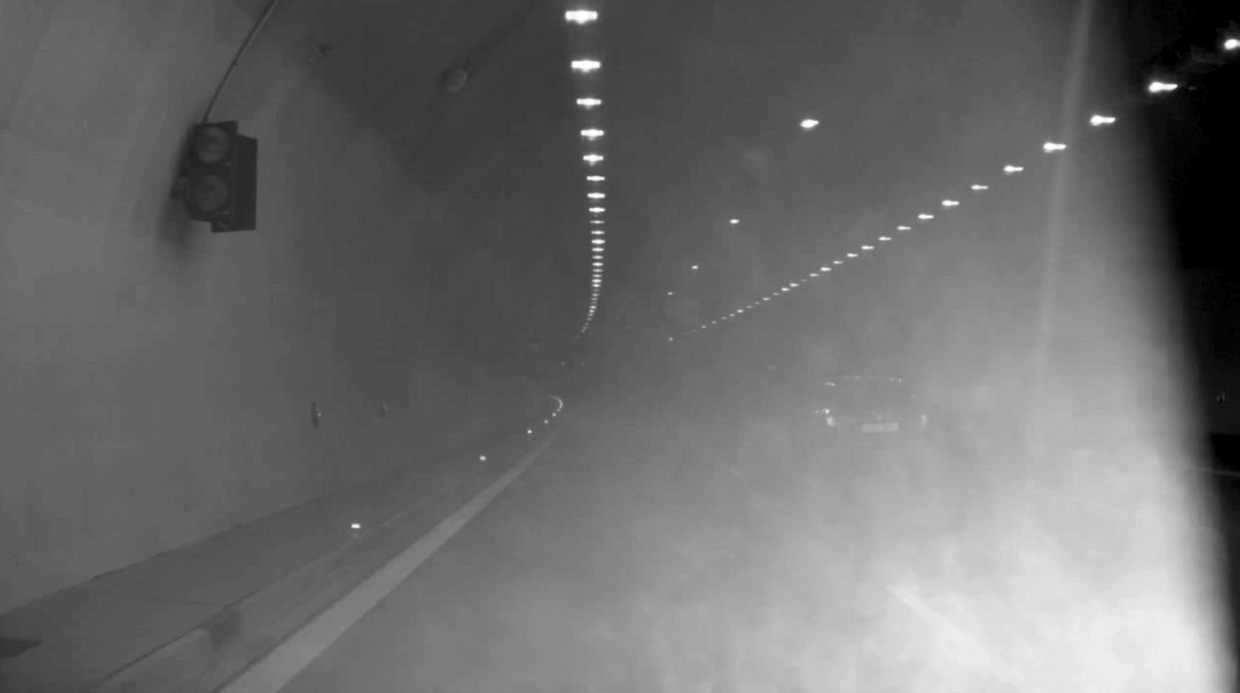 The vehicle is challenging to recognize in this image. stray light